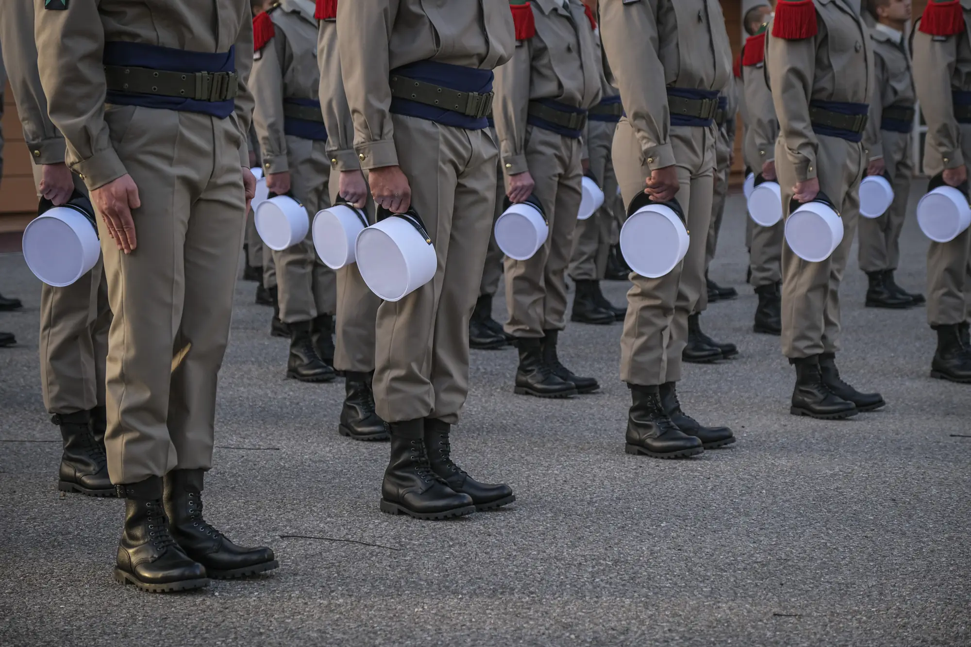 Foreign Legion recruits hold their white képis before the ceremony — documentary series by Fred Marie