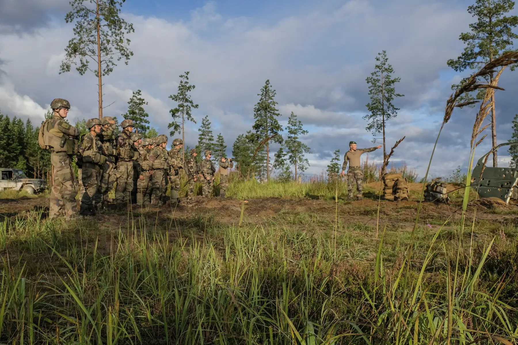 A French platoon lined up on a firing range in golden evening light