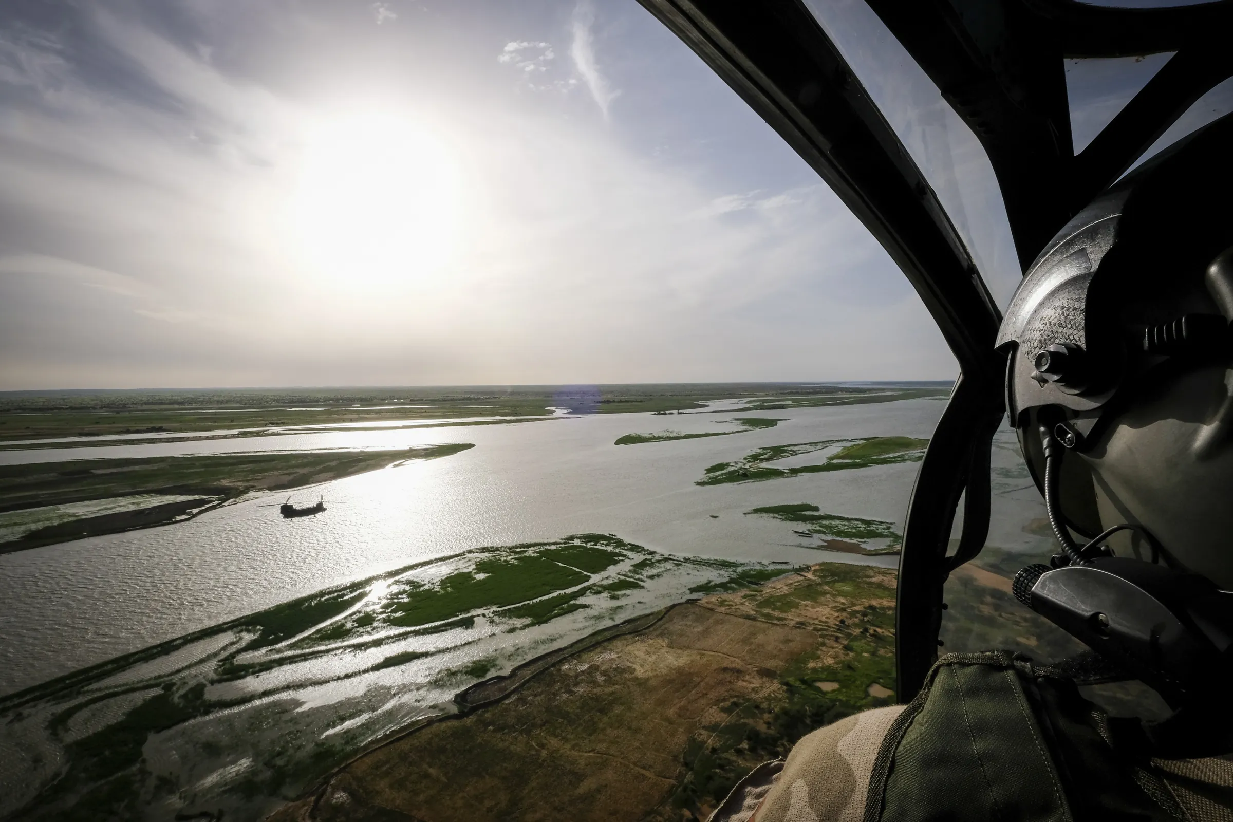Seen from a helicopter cockpit, a British Chinook flies over the Niger River in Mali