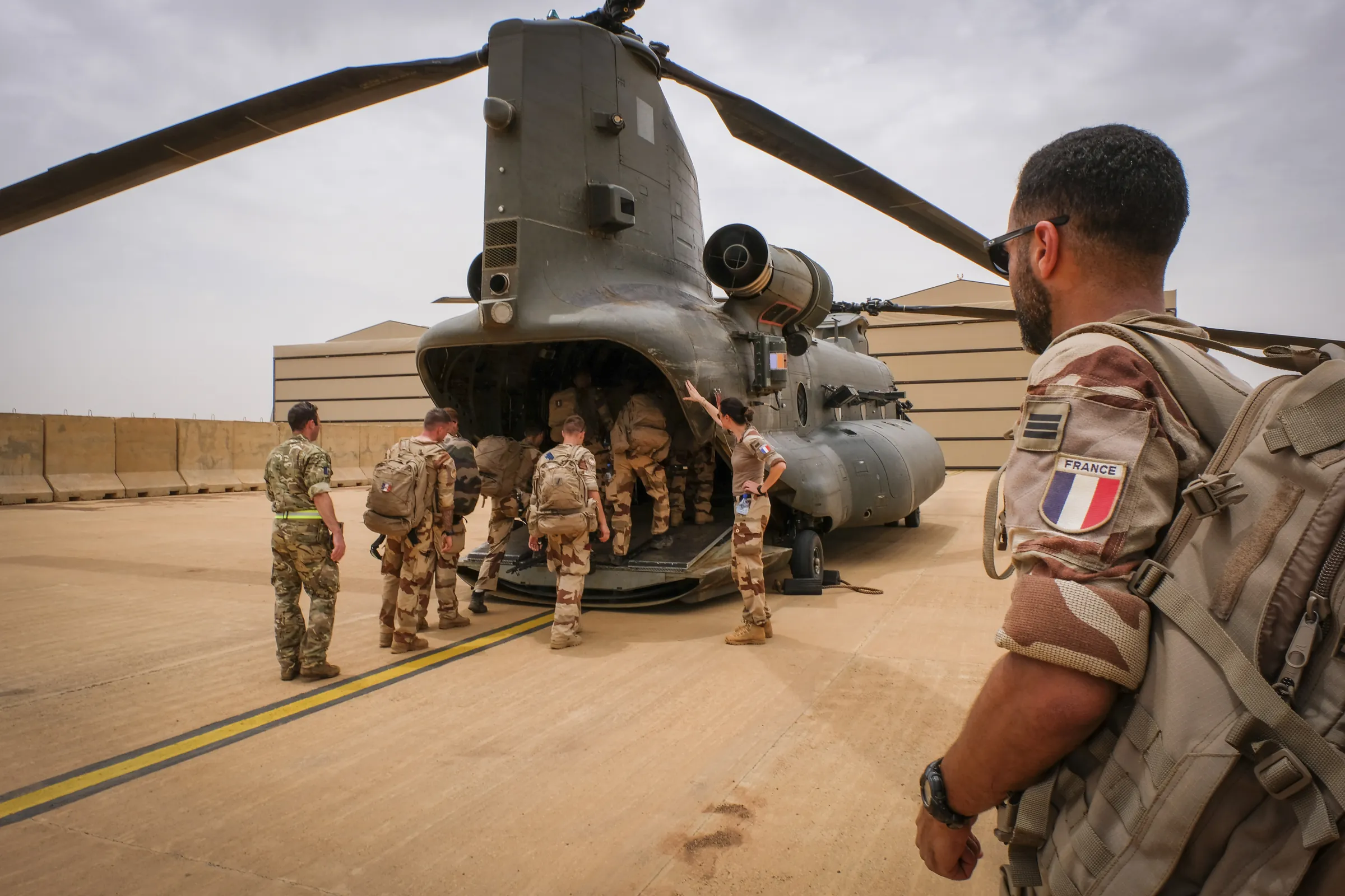 French soldiers board a Royal Air Force Chinook helicopter at Gao air base, Mali