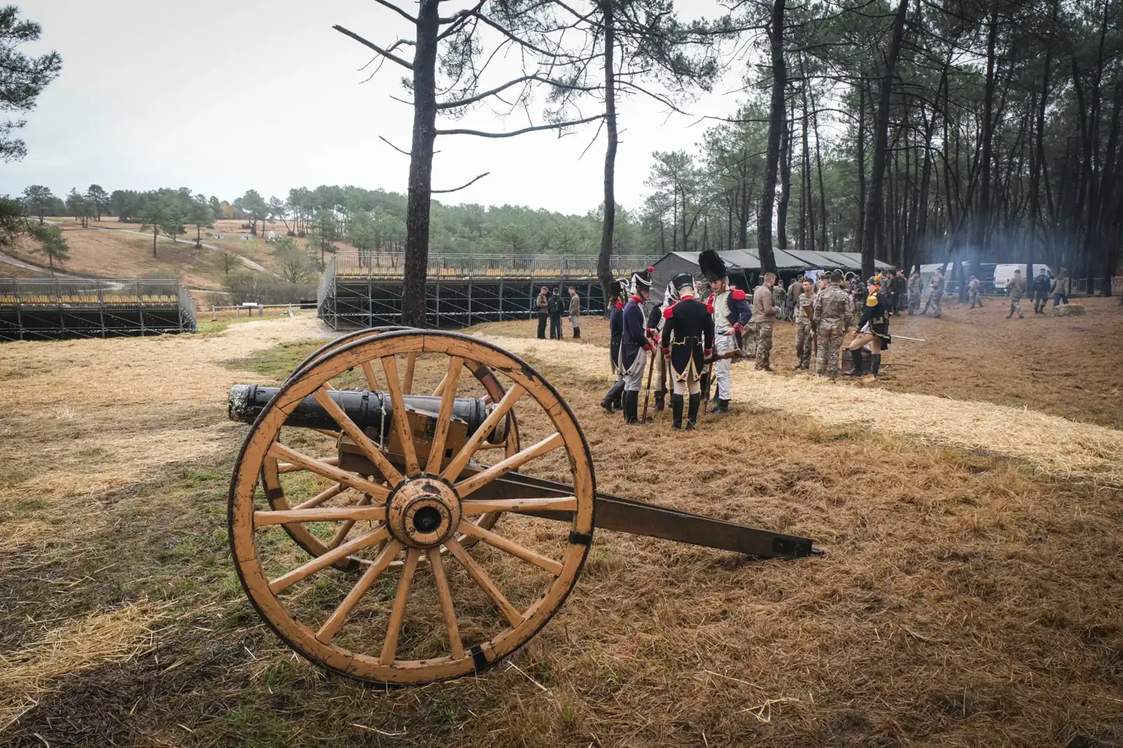 A period field cannon in the foreground as cadets in Napoleonic dress mingle with others in camouflage