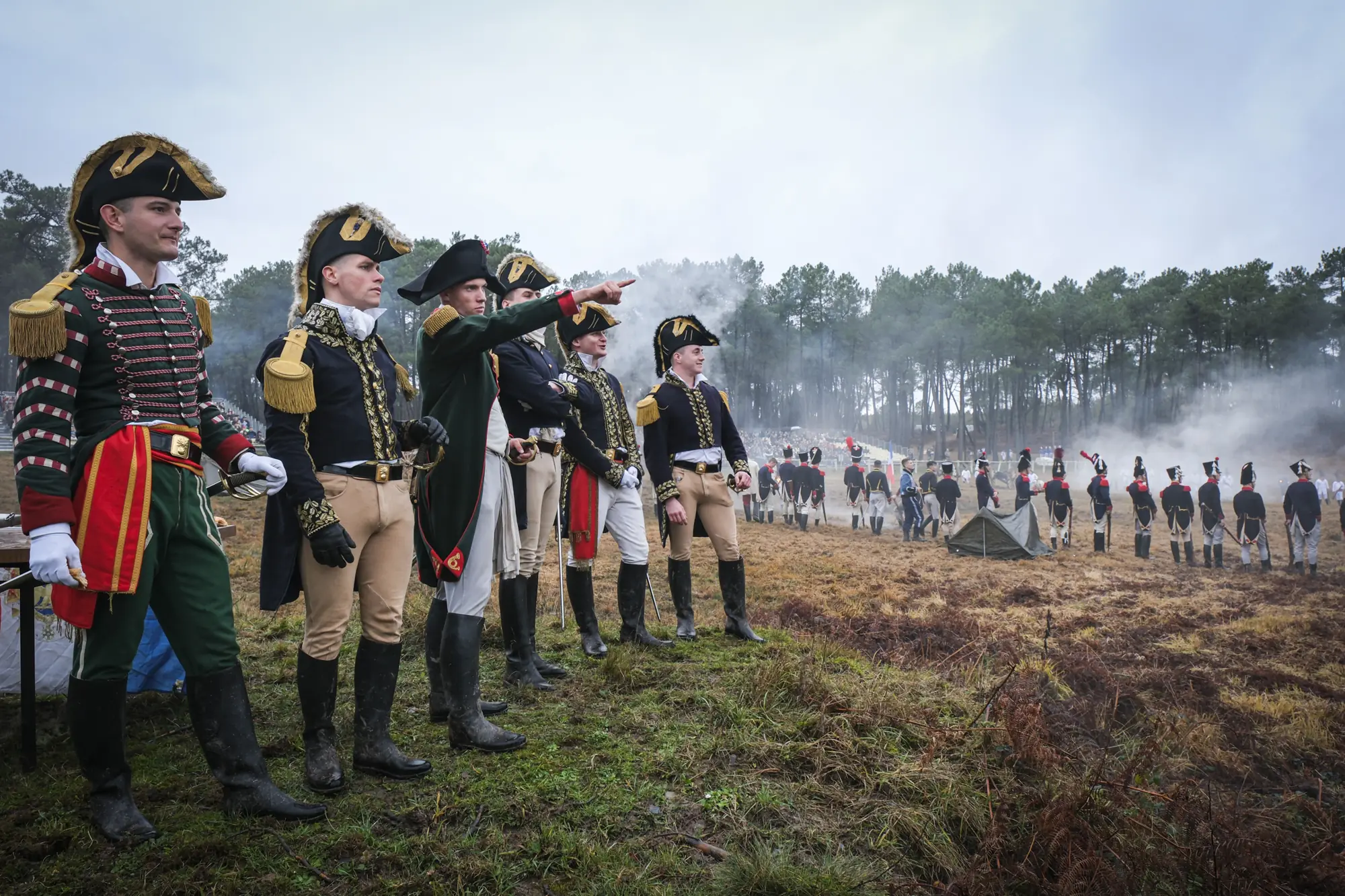 Cadets portraying Napoleon and his staff overlook the smoke-wreathed reenacted battle