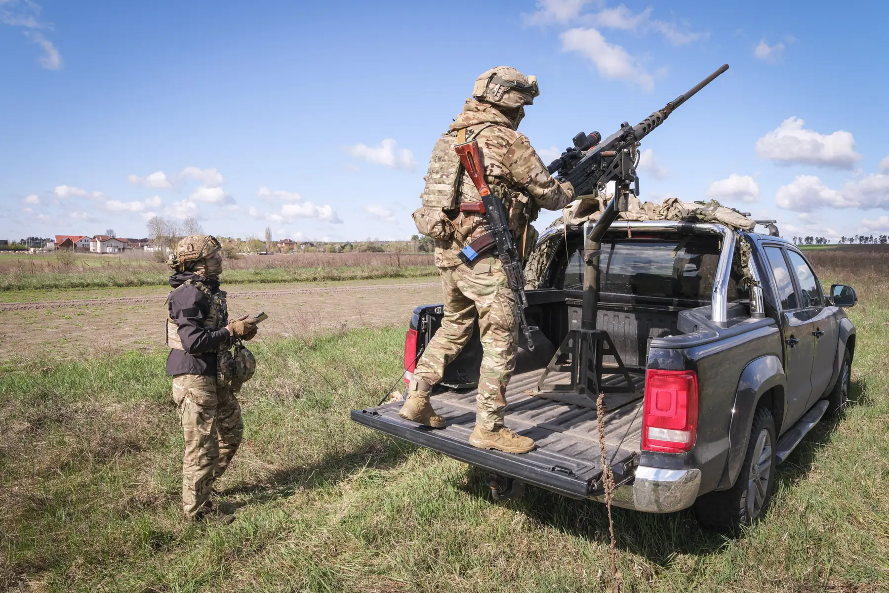 A drone-hunting crew and their heavy machine gun mounted on a pickup truck in Irpin