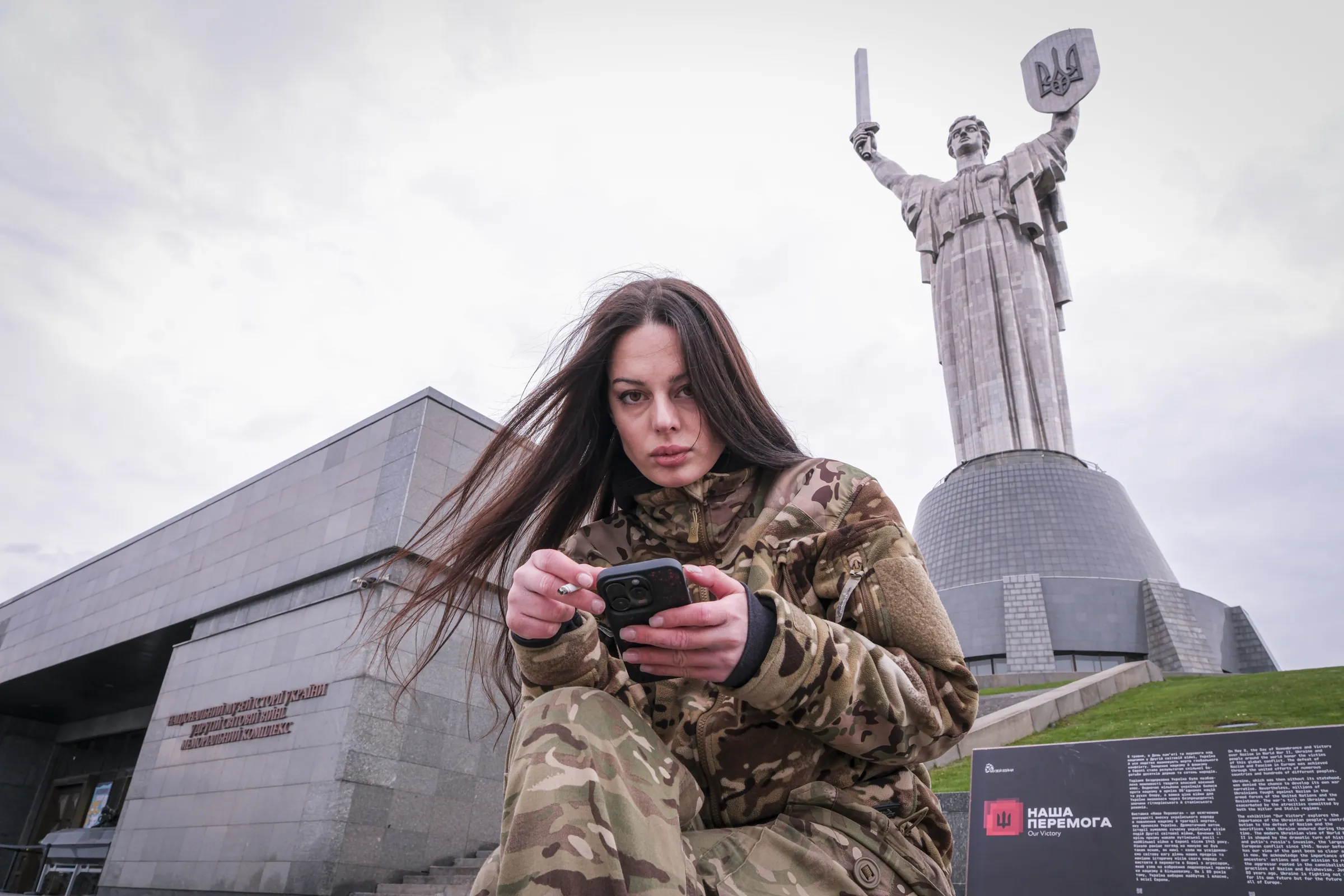 Sasha, a young Russian volunteer fighting for Ukraine, beneath the Motherland Monument in Kyiv